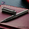 LAMY Safari Charcoal Black Fountain Pen - On a leather notebook image