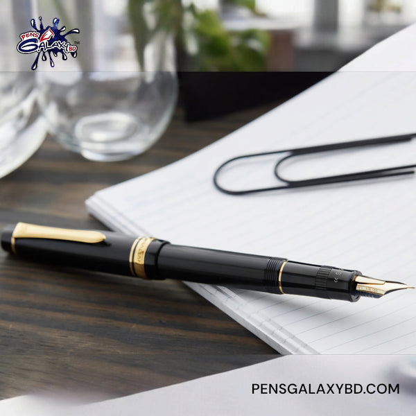 Pilot Justus 95 Fountain Pen - Black/Gold - On a wooden desk beside white paper photography