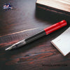 Pilot Kakuno Fountain Pen - Red/Gray - On a dark wooden table with a paper beside image