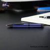 Pilot Vanishing Point Fountain Pen - Matte Blue - On a black desk beside a diary 