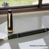 Pilot Justus 95 Fountain Pen - Black/Gold - Full image photography on a white transparent table beside a sliding window